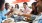 group of people eat and drink around a restaurant table