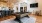 a room with a pool table and chairs
