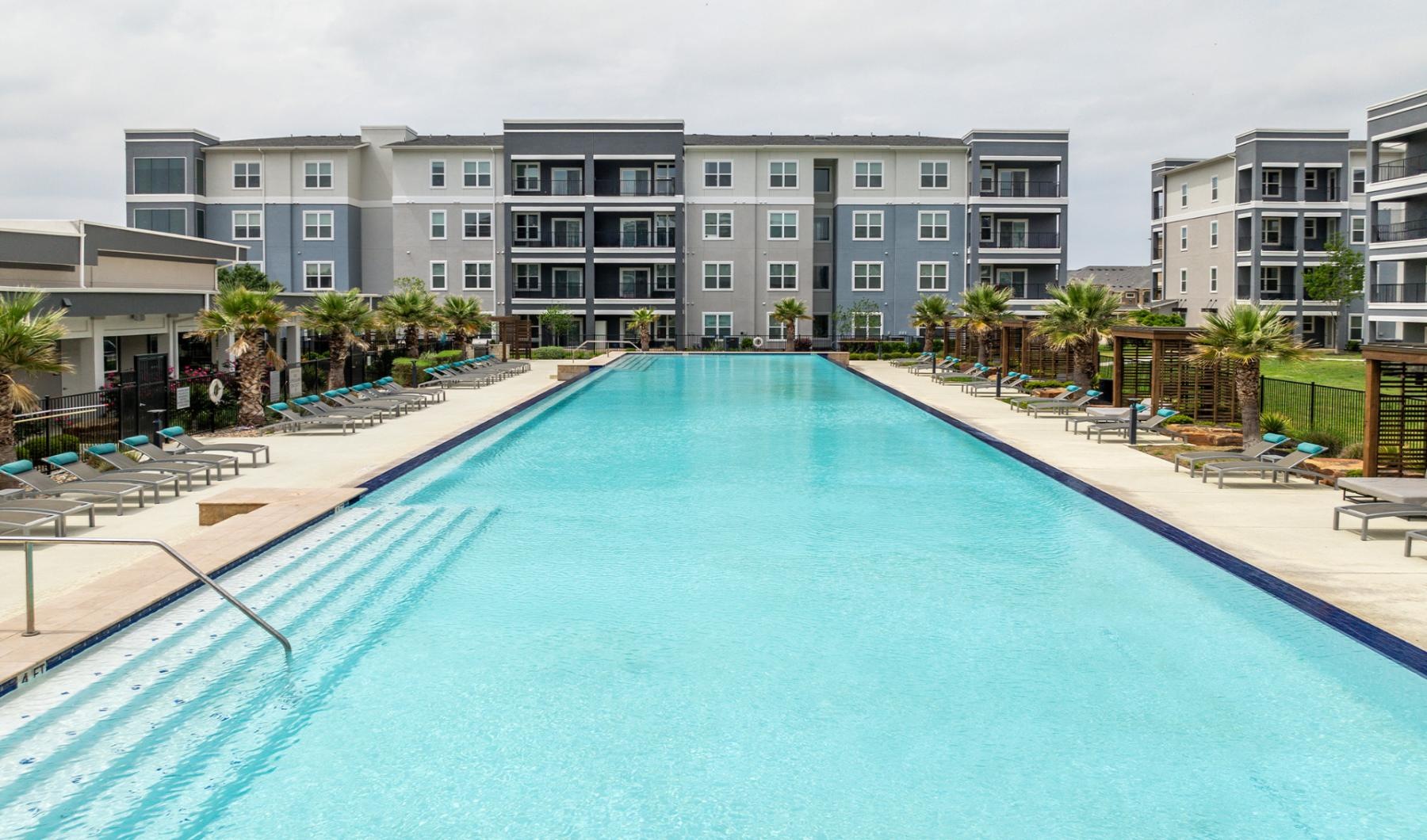 Resort-style swimming pool a swimming pool in front of a building